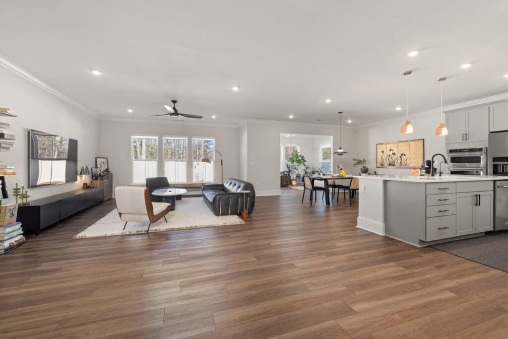 Open concept living room with beautiful hardwood flooring in Houston TX home
