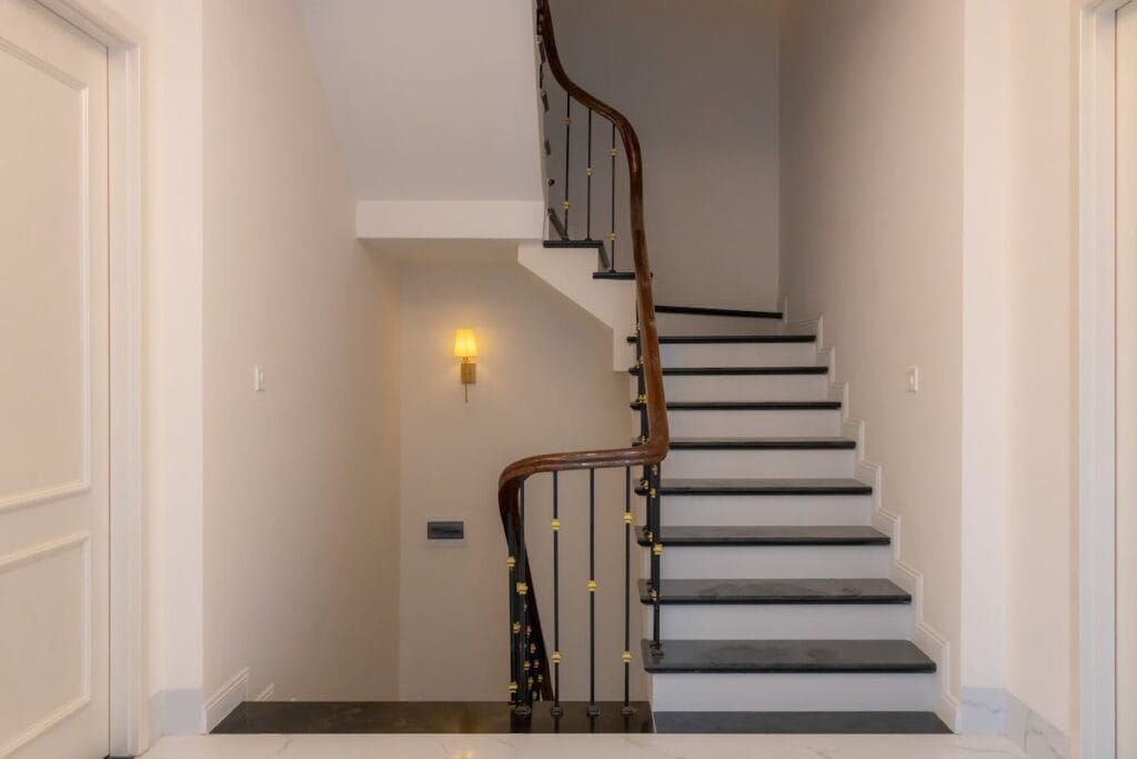 Modern wooden staircase with elegant handrail in Spring TX home